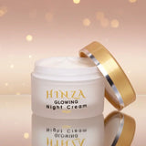 Hinza Glowing Night Cream jar with gold lid on a soft pink background